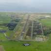 General oblique aerial view looking down the main runway at Machrihanish Airfield, taken from the E.