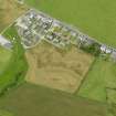 Oblique aerial view centred on the cropmarks of the possible barrow, the drains and field boundary and Wallace Cottages, Southend, taken from the SE.