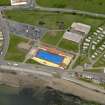 Oblique aerial view centred on the open air swimming pool, Stonehaven, with the Leisure Centre adjacent, taken from the E.