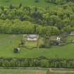 Oblique aerial view centred on the Lodge with Octagon Cottage adjacent, taken from the W.