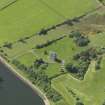 Oblique aerial view centred on the tower house with the remains of the motte (earthworks) adjacent, taken from the SE.