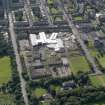 Oblique aerial view centred on Broughton High School and construction site of new school, with Edinburgh City Police HQ to SW, taken from the N.