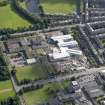 Oblique aerial view centred on Broughton High School and construction site of new school, taken from the W.