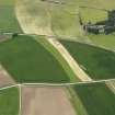 General oblique aerial view centred on the field boundaries with the cemetery adjacent, taken from the NNE.