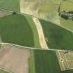 General oblique aerial view centred on the field boundaries with the cemetery adjacent, taken from the N.