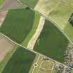 General oblique aerial view centred on the field boundaries with the cemetery adjacent, taken from the NNW.