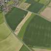 General oblique aerial view centred on the field boundaries with the cemetery adjacent, taken from the SE.