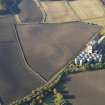 Oblique aerial view of the soilmarks of the fort with the Pentcaitland maltings adjacent, taken from the E.