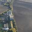 Oblique aerial view of the soilmarks of the fort with the Pentcaitland maltings adjacent, taken from the NW.