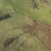 Oblique aerial view of the remains of the buildings and settlement at Cockburn Law, taken from the WNW.