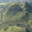 Oblique aerial view of the cultivation terraces and the remains of the fort on Arthur's Seat, taken from the ENE.