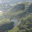 Oblique aerial view of Holyrood Park looking across the remains of the fort and Dunsapie Loch towards Arthur's Seat and the remains of the cultivation terraces and rig, taken from the NE.