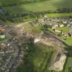 Oblique aerial view centred on the demolition of the distillery, taken from the NW.