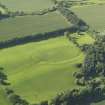 Oblique aerial view centred on the remains of the earthwork and rig, taken from the SE.