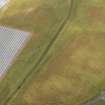 Oblique aerial view of the cropmarks of the rig and furrow, pits and unenclosed round houses at East Scryne, taken from the E.