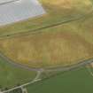 Oblique aerial view of the cropmarks of the rig and furrow, pits and unenclosed round houses at Hatton Farm, taken from the ENE.