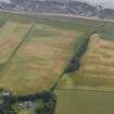 Oblique aerial view centred on the cropmarks of the rig and ring ditch near Hatton House, taken from the NW.