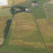 Oblique aerial view centred on the cropmarks of the rig and ring ditch with Hatton Country House beyond, taken from the SE.