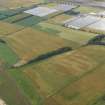 General oblique aerial view of the cropmarks of the rig and ring ditch between Hatton Country House and East Haven, taken from the E.