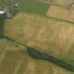 Oblique aerial view centred on the cropmarks of the rig and ring ditch with Hatton Country House adjacent, taken from the SW.