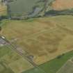 Oblique aerial view centred on the cropmarks of the rig, pits and barrows on Craigmill Farm, taken from the E.