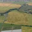 General oblique aerial view centred of the cropmarks of the rig, pits and barrows on Craigmill Farm, taken from the NE.