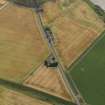 Oblique aerial view centred on the cropmarks of the Roman Temporary Camp, ring ditches, round houses and rig and furrow at Dun, taken from the NW.