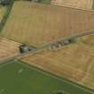 Oblique aerial view centred on the cropmarks of the Roman Temporary Camp, ring ditches, round houses and rig and furrow at Dun, taken from the SW.