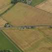 Oblique aerial view centred on the cropmarks of the Roman Temporary Camp, ring ditches, round houses and rig and furrow at Dun, taken from the SSW.