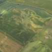 Oblique aerial view of the cropmarks of the round houses, ring ditches, pits and rig and furrow at Leuchars, taken from the NE.