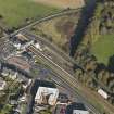 Oblique aerial view centred on the railway station, taken from the SW.