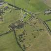 Oblique aerial view centred on the remains of a dispersed domestic site, taken from the NW.