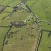 Oblique aerial view centred on the remains of a dispersed domestic site, taken from the NNW.