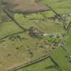 Oblique aerial view centred on the remains of a dispersed domestic site, taken from the NW.