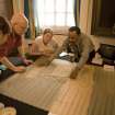 UK team and church officers examining plan of cemetery
