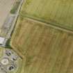 Oblique aerial view centred on the cropmarks of the settlement at Howe Mire, taken from the WNW.