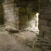 Interior. Sacristy, stone seating and doorway, view from NW
