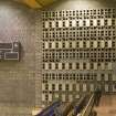 Interior. Detailed view of scoreboard and decorative hollow block wall in Hall 1.