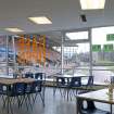 Interior. View of the cafe, looking west through the glazed wall to the stadium.