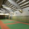 Interior. View of fitness studio showing exposed concrete structure of stadium grandstand.