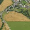 Oblique aerial view of the cropmarks of the rig and furrow, unenclosed settlement and pits at Marykirk, taken from the SE.