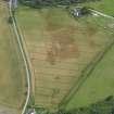 Oblique aerial view centred on the cropmarks of the round houses, rig and pits, taken from the NE.