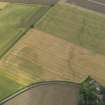 Oblique aerial view centred on the cropmarks of the enclosure, pits and rig, taken from the ESE.