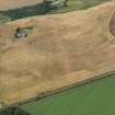 Oblique aerial view centred on the cropmarks of the pit defined enclosure, ring ditch and rig at Laigh of Rossie, taken from the SSE.