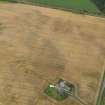 Oblique aerial view centred on the cropmarks of the pit defined enclosure, ring ditch and rig at Laigh of Rossie, taken from the WNW.