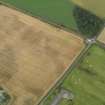 Oblique aerial view centred on the cropmarks of the pit defined enclosure, ring ditch and rig at Laigh of Rossie, taken from the W.