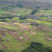 General oblique aerial view of the golf course under construction with Blackford village and The Ochils beyond, taken from the NNW.