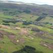 General oblique aerial view of the golf course under construction with Blackford village and The Ochils beyond, taken from the NNW.