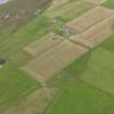 Oblique aerial view centred on the farmstead with burnt mound adjacent, taken from the NE.