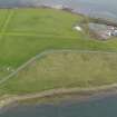 Oblique aerial view centred on the remains of a tramway with the quarry adjacent, taken from the NW.